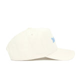 The North Carolina Sideline Hat by No Rivals is a cream-colored, high-quality cotton cap with small ventilation holes, a structured fit, and light blue "North Carolina" text embroidered on the front.