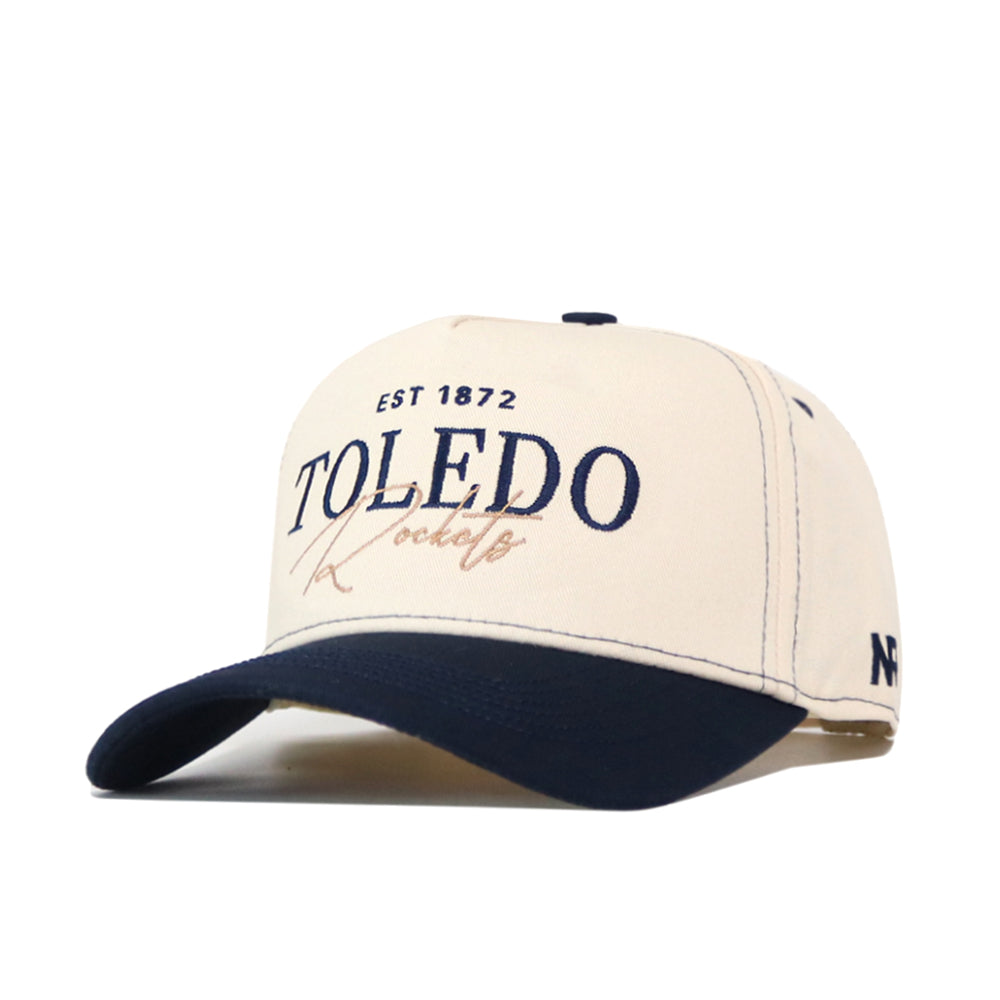 No Rivals Toledo Rockets Vintage Hat in beige and navy, featuring an officially licensed EST 1872 TOLEDO Rockets embroidered logo on the front, a snapback closure, and a stitched N logo on the side.