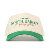 A North Dakota Vintage Hat by No Rivals featuring a white and green design with an officially licensed EST 1883 NORTH DAKOTA Fighting Hawks embroidered logo in green and gold on the front.