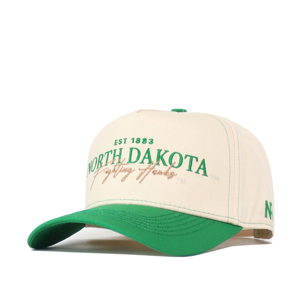 Introducing the North Dakota Vintage Hat by No Rivals, featuring a beige and green design with “North Dakota Fighting Hawks EST 1883” embroidered on the front in striking green and gold lettering. This officially licensed cap comes with a green bill, an embroidered logo, and “ND” detail on the left side. The snap back closure offers a comfortable and adjustable fit.
