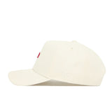 The No Rivals Arkansas Sideline Hat is a cream-colored baseball cap made from high-quality cotton, with white embroidered NR initials on the side and a small red front design.