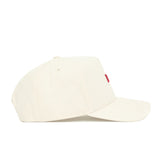 The No Rivals Arkansas Sideline Hat is an off-white cotton baseball cap with a curved brim and a small red tag on the front, shown from the side for a sleek, comfortable, and durable look.