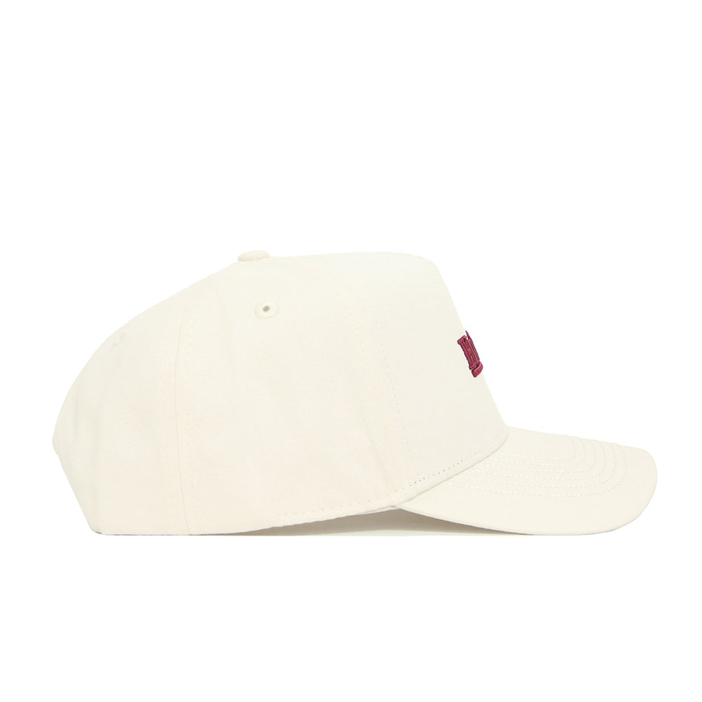 The No Rivals Virginia Tech Sideline Hat is an off-white cotton snapback with a curved brim and subtle stitching. Seen from the side, this structured fit cap displays a partially visible red logo on the front.