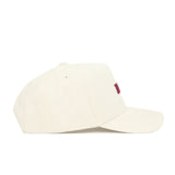 The No Rivals Virginia Tech Sideline Hat is an off-white cotton snapback with a curved brim and subtle stitching. Seen from the side, this structured fit cap displays a partially visible red logo on the front.