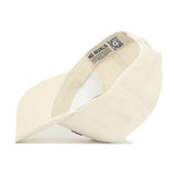 The Virginia Tech Sideline Hat by No Rivals is a cream-colored snapback made of high-quality cotton, shown inside out to display its inner band with printed text and a QR code, resting on a white surface.