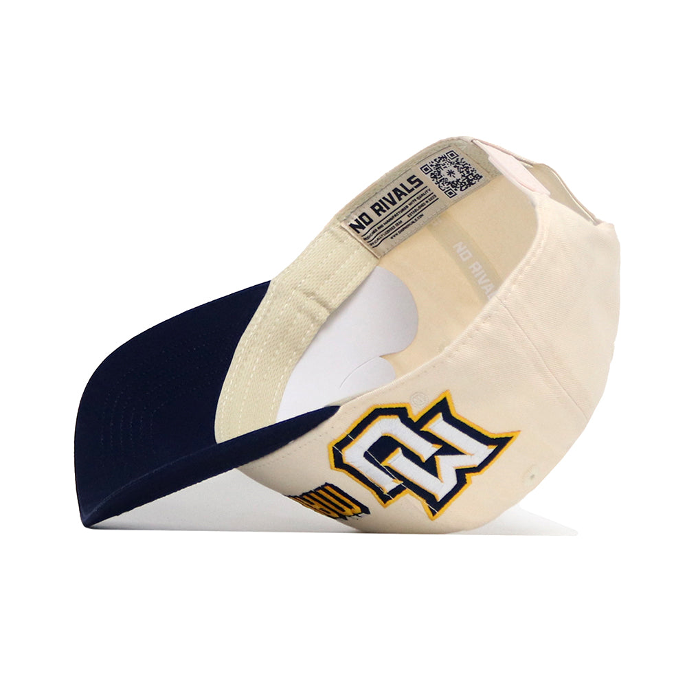 The Marquette Alma Mater Hat by No Rivals is a cream snapback with a navy brim, crafted from premium cotton. It features a bold GW logo in navy and gold stitching, plus "NO RIVALS" text on the inner band.