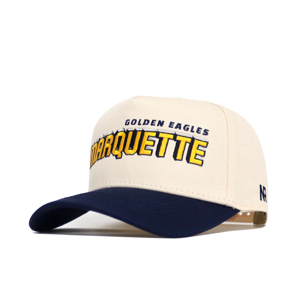 The No Rivals Marquette Alma Mater Hat is a beige and navy snapback made from high-quality cotton, featuring "GOLDEN EAGLES MARQUETTE" embroidered in yellow/navy and an R logo on the side. Officially licensed.