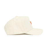 The Tennessee Sideline Hat by No Rivals is a structured, off-white baseball cap with a small orange stitched detail on the front panel, shown from the side.
