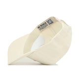 The Tennessee Sideline Hat by No Rivals is a cream snapback, shown upside down to display the inside label with "NO RIVALS" text and a QR code under the brim. It has a structured fit and high-quality, unadorned cotton exterior.