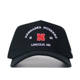 The No Rivals Nebraska Outlaw Hat in black features “Nebraska Huskers 1869 Lincoln NE” along with a bold red embroidered “N” logo on the front—perfect for completing your gameday outfit.