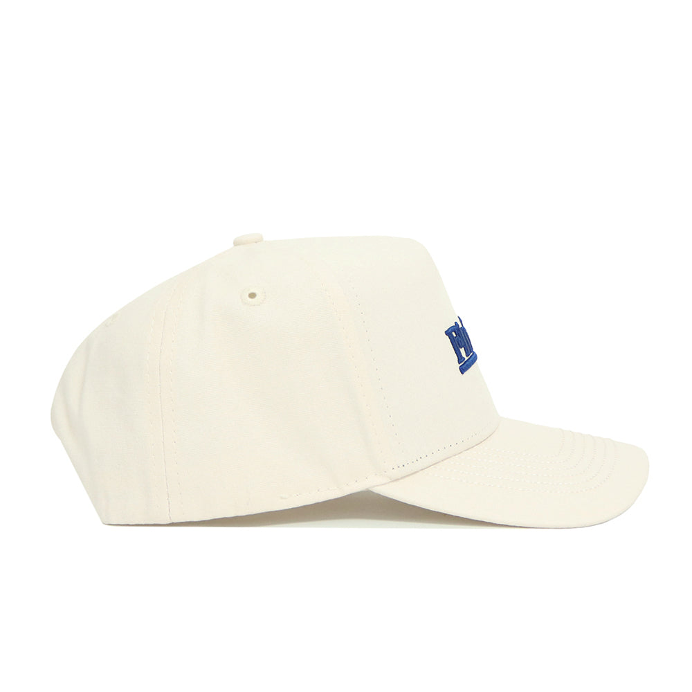 The No Rivals Florida Sideline Hat is a cream-colored, structured cotton baseball cap with a curved brim, small blue front embroidery, stitched eyelets, and a top button. Shown in profile.
