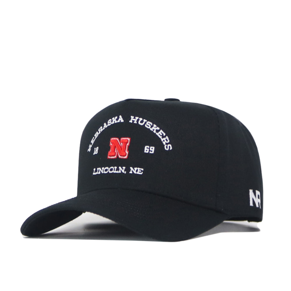 The Nebraska Outlaw Hat - Black by No Rivals is a black snapback featuring Nebraska Huskers and Lincoln, NE embroidered in white, a bold red “N” logo and “1869” on the front. The side showcases white “NR” initials, making it the perfect gameday fit for any fan.