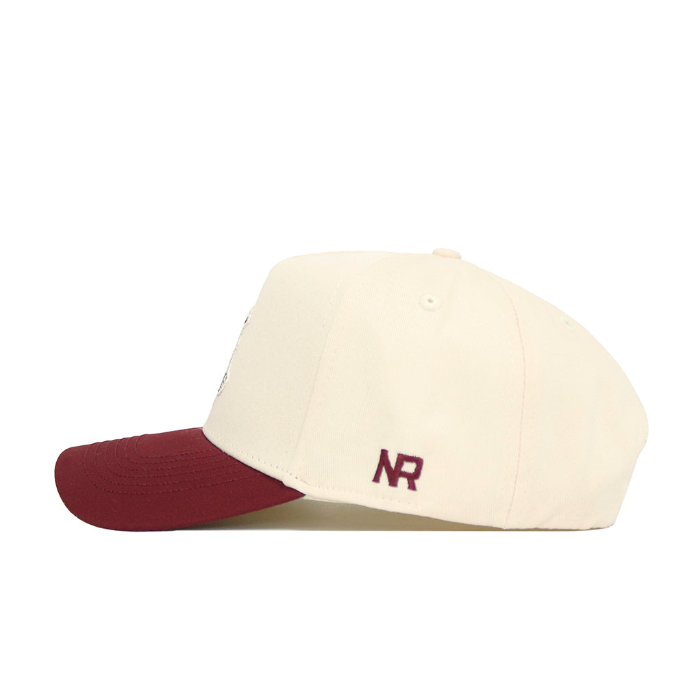 The Texas A&M Ol' Sarge Basketball Hat - Classic by No Rivals features a cream snap back with a dark red brim and NR initials embroidered in dark red, offering a structured, sporty style.