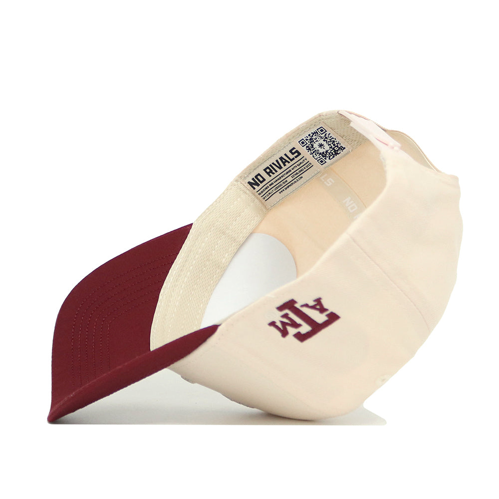 The Texas A&M Ol' Sarge Basketball Hat - Classic by No Rivals is shown upside down, highlighting the inside label, QR code, NO RIVALS tag, and a maroon ATM logo on the front. This Snap Back hat combines style and comfort.