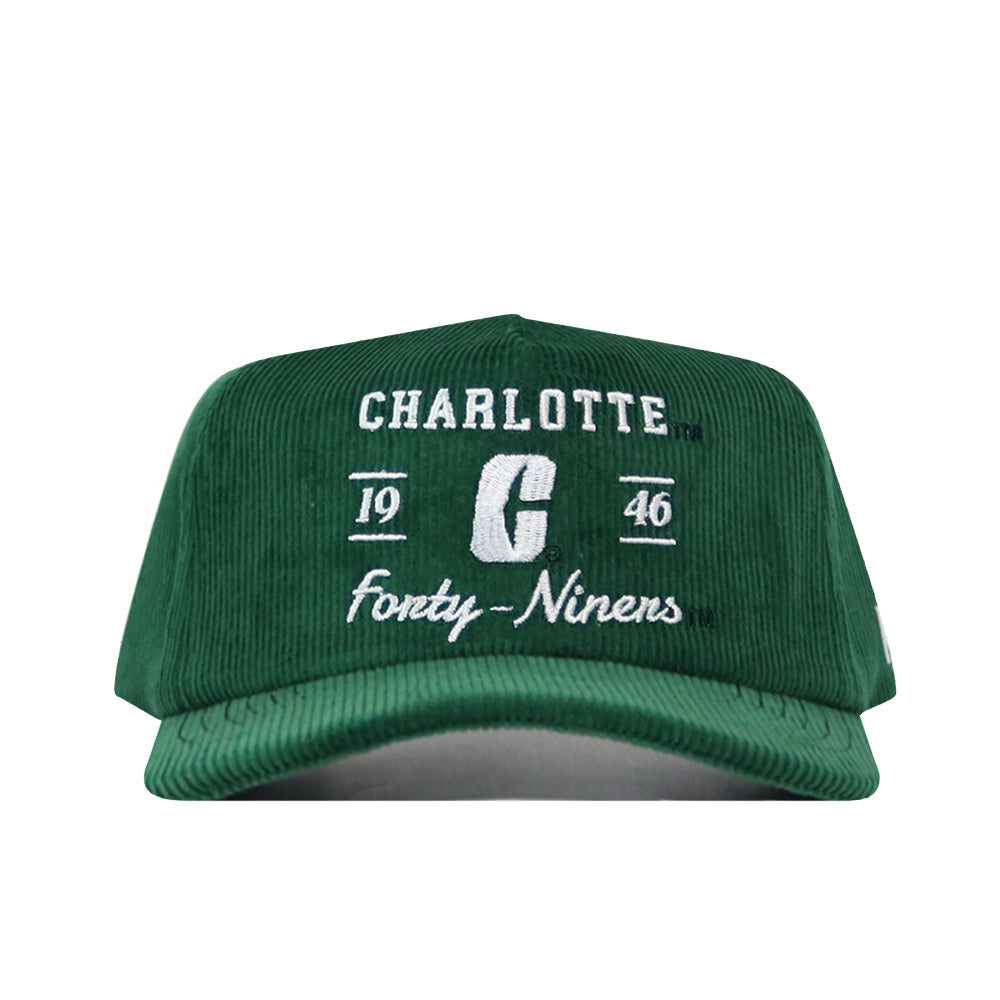 Introducing the Charlotte Vintage Cord Hat by No Rivals—a green cotton corduroy cap featuring white embroidered logos: “Charlotte,” “1946,” a bold “C,” and “Forty-Niners.” It’s finished with a convenient snap back for the perfect fit.