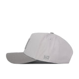 The No Rivals Nebraska Graphite Hat is a light grey baseball cap with a contrasting darker grey brim, displayed here from the side. It features an embroidered NR logo stitched near the back on the side panel, giving this cap its signature classic gameday fit.