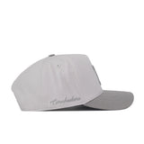 The No Rivals Nebraska Graphite Hat is a light gray baseball cap with “Cornhuskers” embroidered on the side in matching gray thread and a classic logo on the front, designed for a timeless gameday look, shown in side view against a white background.