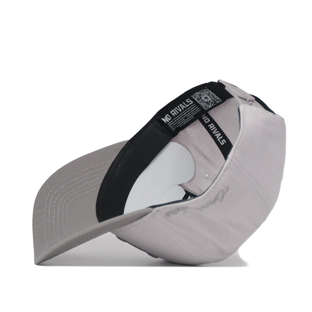 The Nebraska Graphite Hat by No Rivals, flipped inside out, reveals its black inner band labeled NO RIVALS and the white interior support structure.