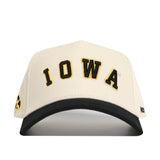 The Right Side Up Iowa Hat - Classic by No Rivals features a white snapback design with the word "IOWA" boldly embroidered in black and yellow on the front, complemented by a black curved brim—ideal for finishing your gameday look.