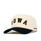 Presenting the No Rivals Right Side Up Iowa Hat - Classic: This cream baseball cap showcases a bold black and gold embroidered IOWA logo on the front and a stylish curved black brim. "NO RINGS" is stitched in black on the side, making this snapback hat the ideal choice for your next gameday outfit.