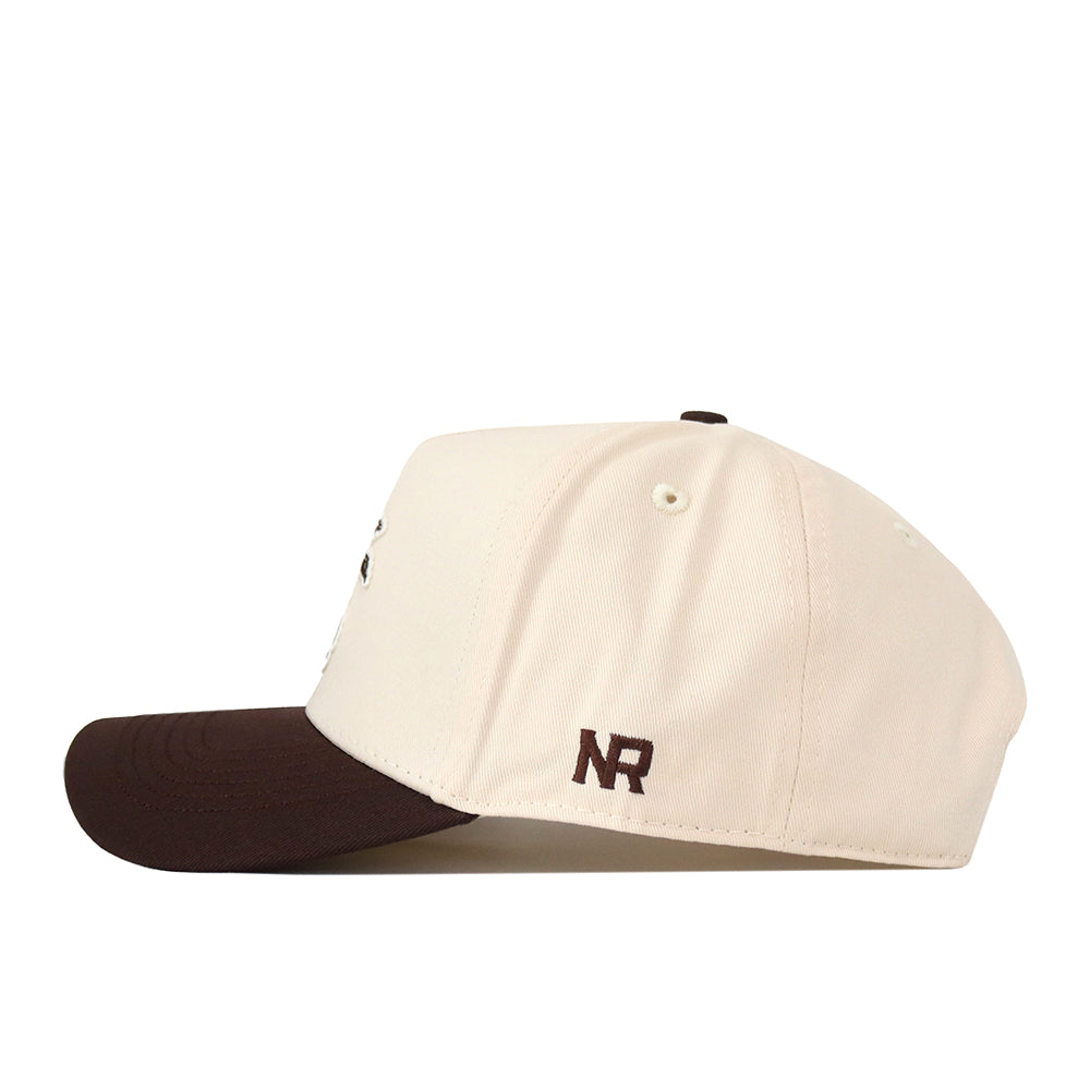 The Wichita State Espresso Hat by No Rivals is a cream cotton baseball cap with a dark brown brim, snapback closure, and NR embroidered in brown thread near the back.
