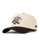 The Wichita State Espresso Hat by No Rivals features a beige and brown snapback design, a cartoon baseball player on the front, NR on the side, and is crafted from high quality cotton.