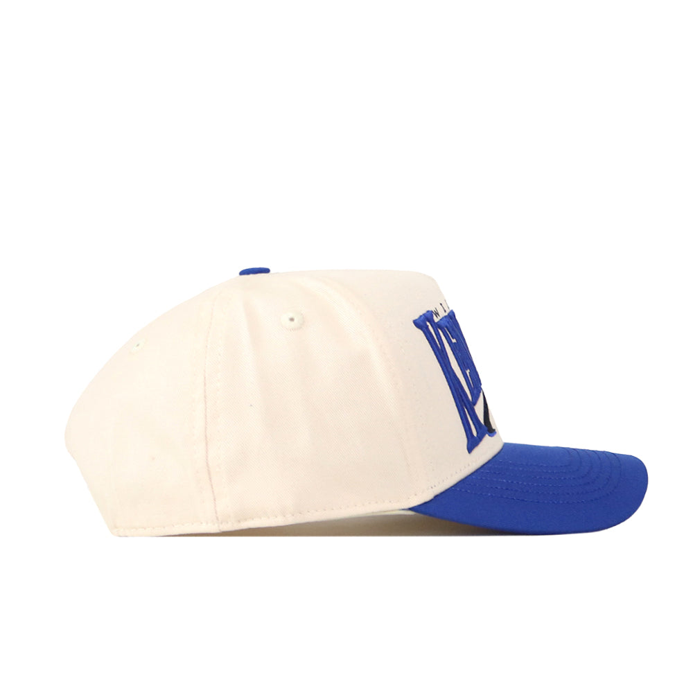 The No Rivals Kentucky Wildcats Stride Hat is a structured fit cap made from high-quality cotton, showcasing a white crown with a blue brim and a bold blue "N" logo on the front, displayed in a left-side profile view against a clean white background.