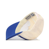The No Rivals Kentucky Wildcats Stride Hat is pictured upside down on a white surface, displaying its cream and blue cotton interior, tags, and structured brim.