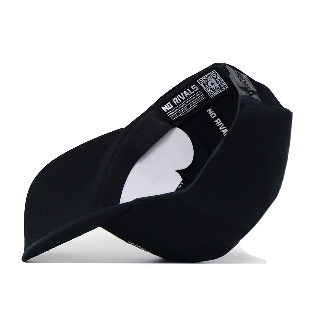 The UNC Outlaw Hat - Black by No Rivals is shown turned inside out, revealing the “NO RIVALS” label and a QR code on the inner band, along with white cardboard inserts that help maintain its structured fit.