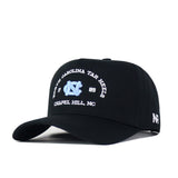 The UNC Outlaw Hat – Black by No Rivals features a structured fit and showcases the North Carolina Tar Heels, 1789, and Chapel Hill, NC, with a light blue embroidered logo on the front. The side displays a white “NR” embroidery, and the snap back closure ensures adjustable comfort.