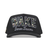 The No Rivals Wake Forest Camo Block Hat is a black snapback featuring bold, camouflage-patterned “WAKE” lettering with “Demon Deacons” embroidered in white script underneath on the front—making it the perfect standout gameday accessory with eye-catching embroidered logos.