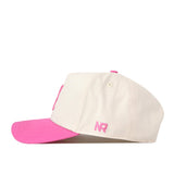 The Alabama Pink Out Hat by No Rivals is a white snapback cap with a pink brim and pink NR initials on the side, shown in a side profile against a white background.