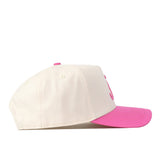 The Alabama Pink Out Hat by No Rivals features a white snapback design with a bright pink brim and top button, shown from the side on a plain white background—a stylish nod to breast cancer awareness.