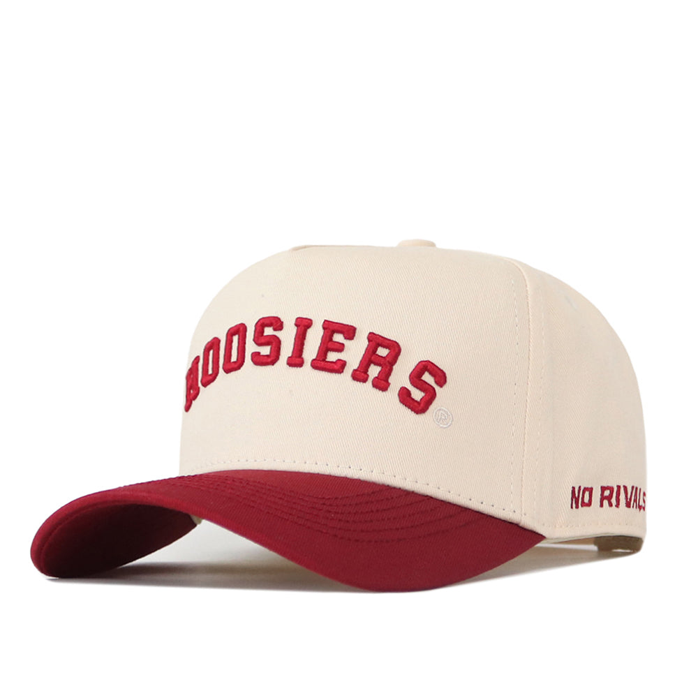 Introducing the Right Side Up Hoosiers Hat - Classic Colors by No Rivals. This officially licensed cream baseball cap features “HOOSIERS” embroidered in bold red letters on the front and “NO RIVALS” stitched in red on the side. The maroon brim adds a stylish touch, while the snapback design ensures a comfortable fit—making it an ideal choice for any fan’s collection.