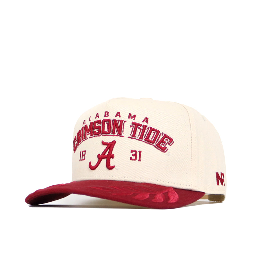 The Alabama Rally Hat by No Rivals is a beige and red snapback with the Alabama Crimson Tide logo—featuring a large A and 1831—embroidered on the front, NR stitched on the side, and a subtly patterned red brim. Made from high quality cotton.