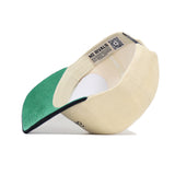 The Tennessee Traditions Hat by No Rivals is shown upside down, displaying its beige and green structured fit, green undervisor, white lining, snapback closure, QR code label, and "NO RIVALS" on the inner band.