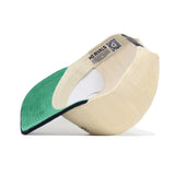 The Texas A&M Traditions Hat by No Rivals is a beige and green snapback shown upside down, highlighting the NO RIVALS inner band text and a visible QR code beneath the structured brim.