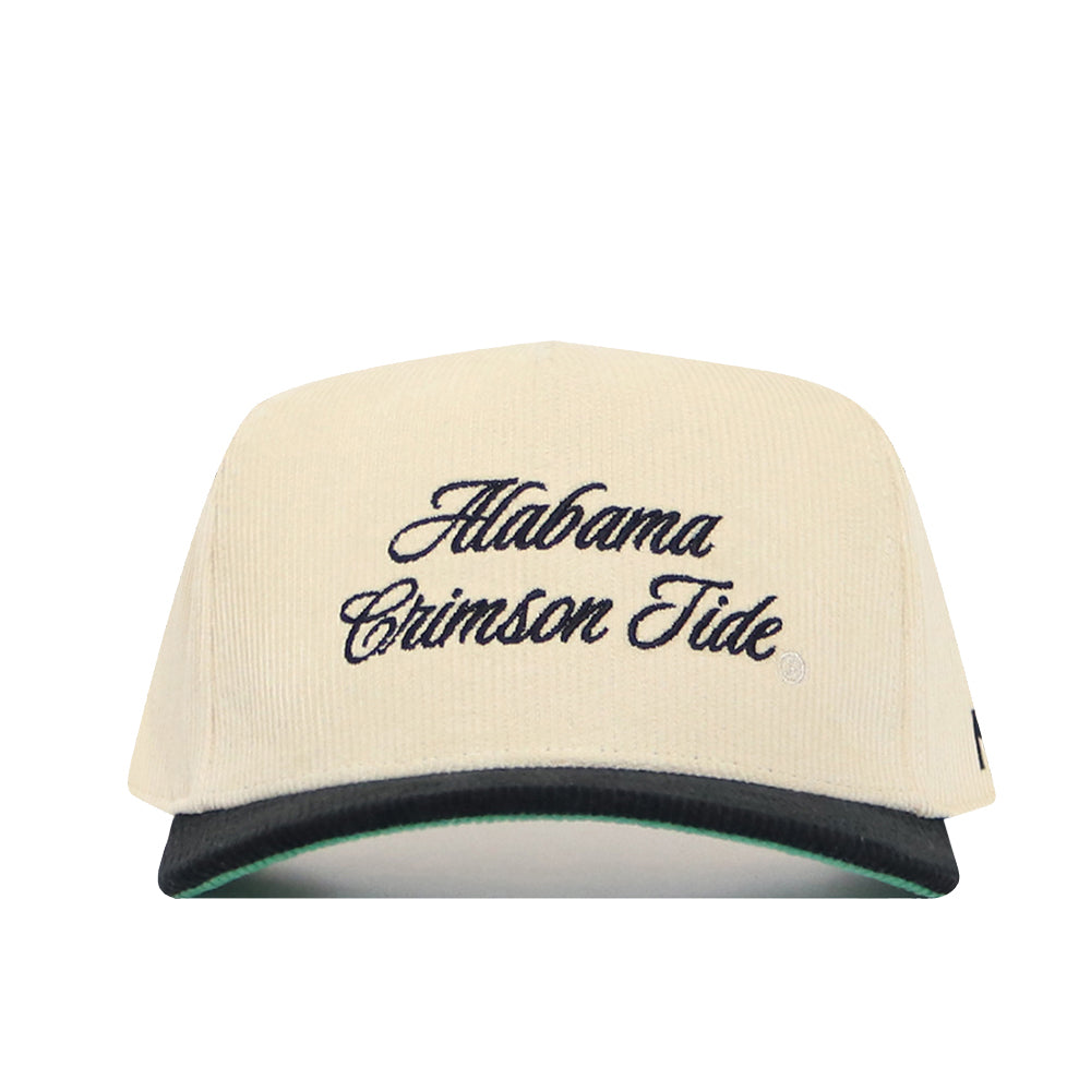 The No Rivals Alabama Traditions Hat is a cream snapback with "Alabama Crimson Tide" embroidered in black script, featuring a structured fit, high-quality cotton, a black brim, and a green underside.