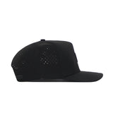 The Texas A&M Trainer Hat by No Rivals is a black snapback with a flat brim and side ventilation holes, displayed in side profile against a white background.