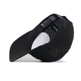 The Indiana Trainer Hat by No Rivals is a black mesh baseball cap shown upside down on a white surface, displaying the inside NO RIVALS label, ventilation holes on the back and sides, and a Snap Back Adjustment.