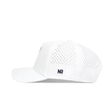 The Miami Golf Hat - White by No Rivals features side and back ventilation holes, a solid front panel with a small black NR logo patch on the side, and a snapback closure. Shown in side profile.