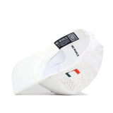 The Miami Golf Hat - White by No Rivals is a white snapback cap with small ventilation holes, embroidered side graphics featuring a colorful logo, and an interior black label displaying the NO RIVALS name and a QR code.
