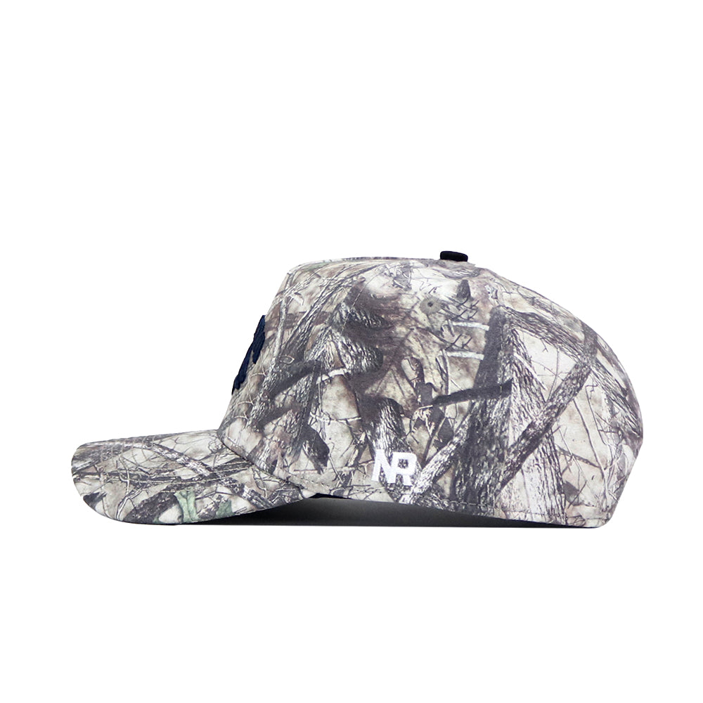Side view of the No Rivals Nevada Wolfpack Outland Hat in gray and brown camo, featuring a structured fit, flat brim, white NB lettering near the brim, and a snapback adjustable closure for a custom fit.