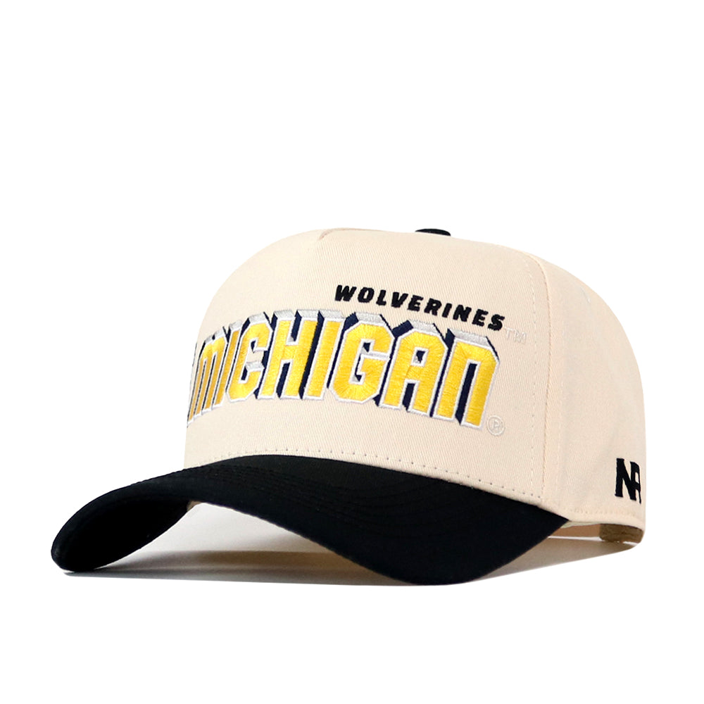 Introducing the Michigan Wolverines Alma Mater Hat by No Rivals—a beige cap with a black bill, featuring “WOLVERINES” and “MICHIGAN” in yellow and blue embroidered on the front, the NR logo on the side, and a classic Snap Back closure for an ideal gameday fit.