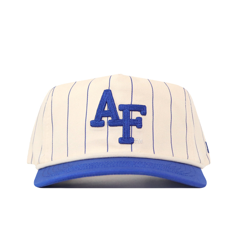 The No Rivals Air Force Pinstripe Hat is an officially licensed snap back cap featuring a cream color with blue pinstripes, a blue brim, and bold blue “AF” letters on the front. Its unstructured fit ensures relaxed comfort and effortless style.