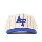 The No Rivals Air Force Pinstripe Hat is an officially licensed snap back cap featuring a cream color with blue pinstripes, a blue brim, and bold blue “AF” letters on the front. Its unstructured fit ensures relaxed comfort and effortless style.