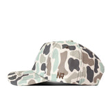 A Texas State Huntsman Hat by No Rivals, featuring a camouflage pattern in shades of green, beige, and brown, with an embroidered NP logo on the side. Designed for the perfect gameday fit, this snapback cap is shown positioned sideways on a white background.