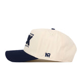 A side view of the No Rivals Georgia Southern Erk Russell Hat, featuring a cream-colored crown with a navy blue bill. The cap displays an embroidered NR logo on the left side and includes a snap back closure for easy adjustment.
