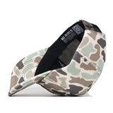 The Boise State Huntsman Hat by No Rivals is pictured on its side, revealing the interior black band and a NO RIVALS label. This officially licensed Snap Back cap features a camouflage pattern in shades of green, brown, and beige for a classic look.