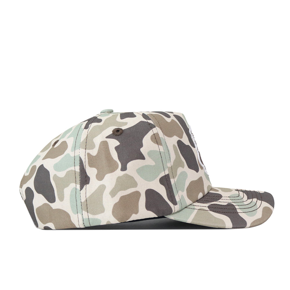 The Wichita State Huntsman Hat by No Rivals is a high-quality cotton baseball cap in green, brown, and beige camo with a flat brim and top button, shown from the side on a white background.